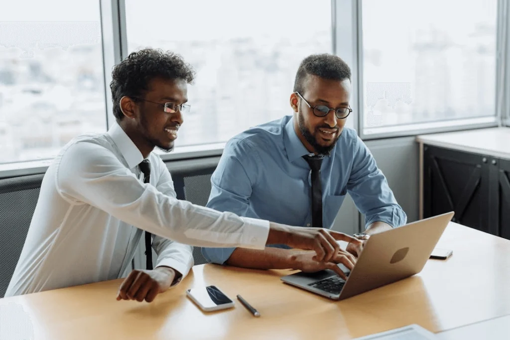 Consultant reviewing Solana network adoption trends on laptop with financial data charts
